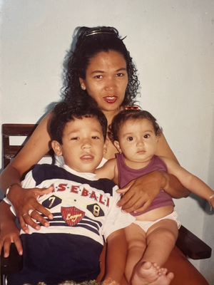 Photo of Julian from childhood with his mom and his sister, Jessica