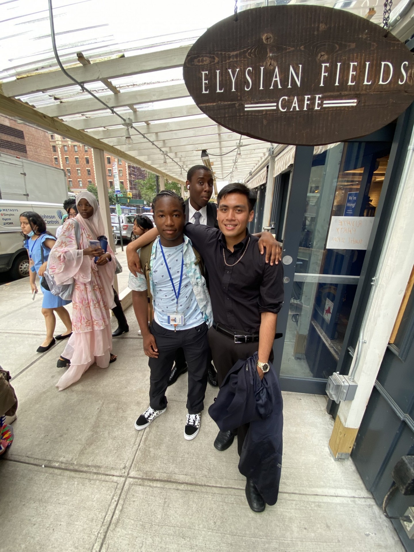Abel and Student in Freedom and Citizenship Program stand outside elysian fields cafe