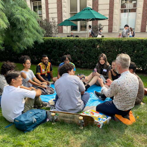 students sitting on grass and chatting