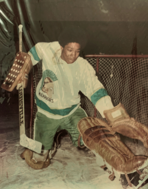 Dennis playing hockey in the 1970s