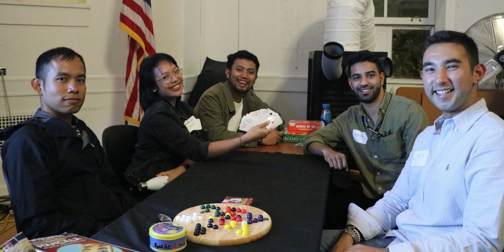 Students play cards at speed friending event