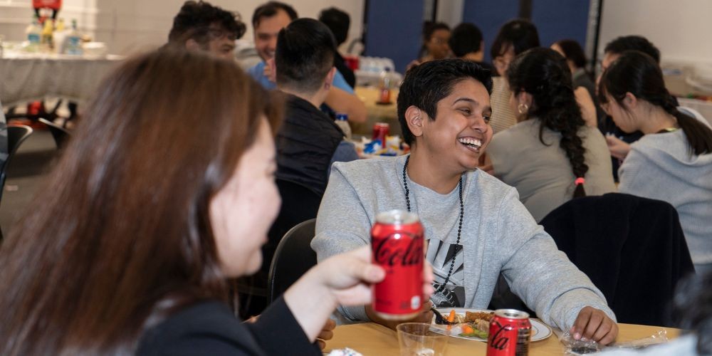 Students chatting and laughing at Dinner with Strangers