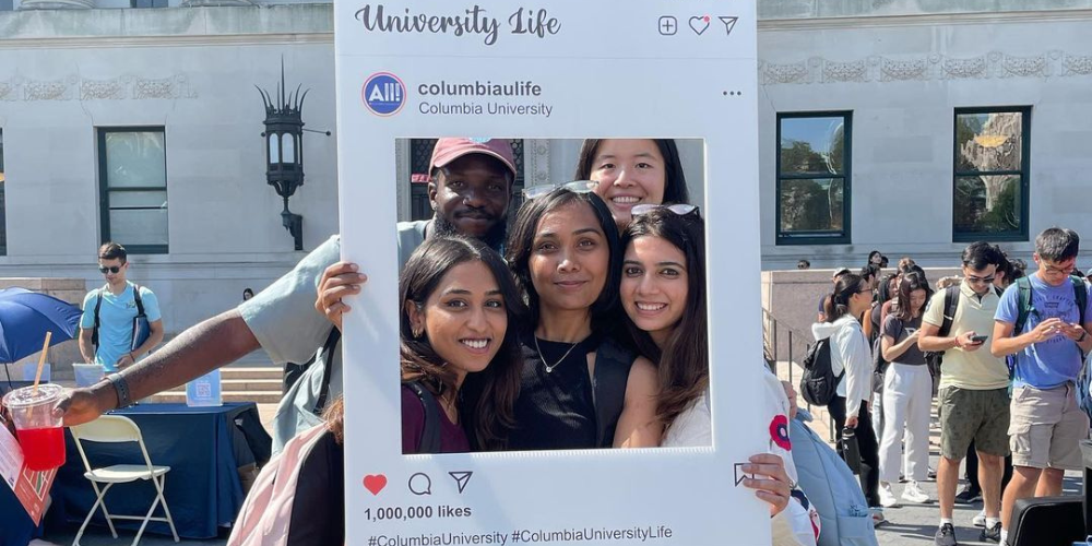 Students pose in University Life Instagram frame