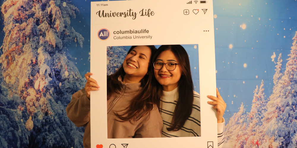 Two students pose with University Life Instagram Frame 