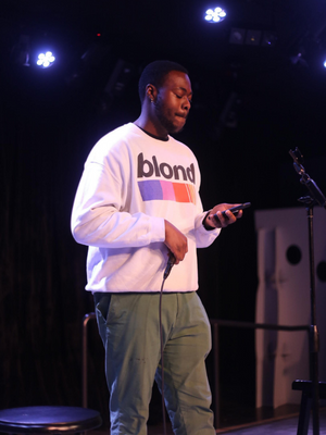 James holding microphone onstage