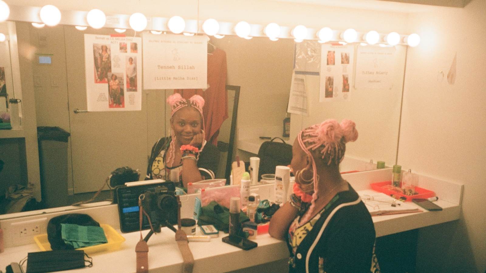 Tenneh backstage poses for photo in the mirror