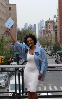 Jada lifts her grad cap in celebration