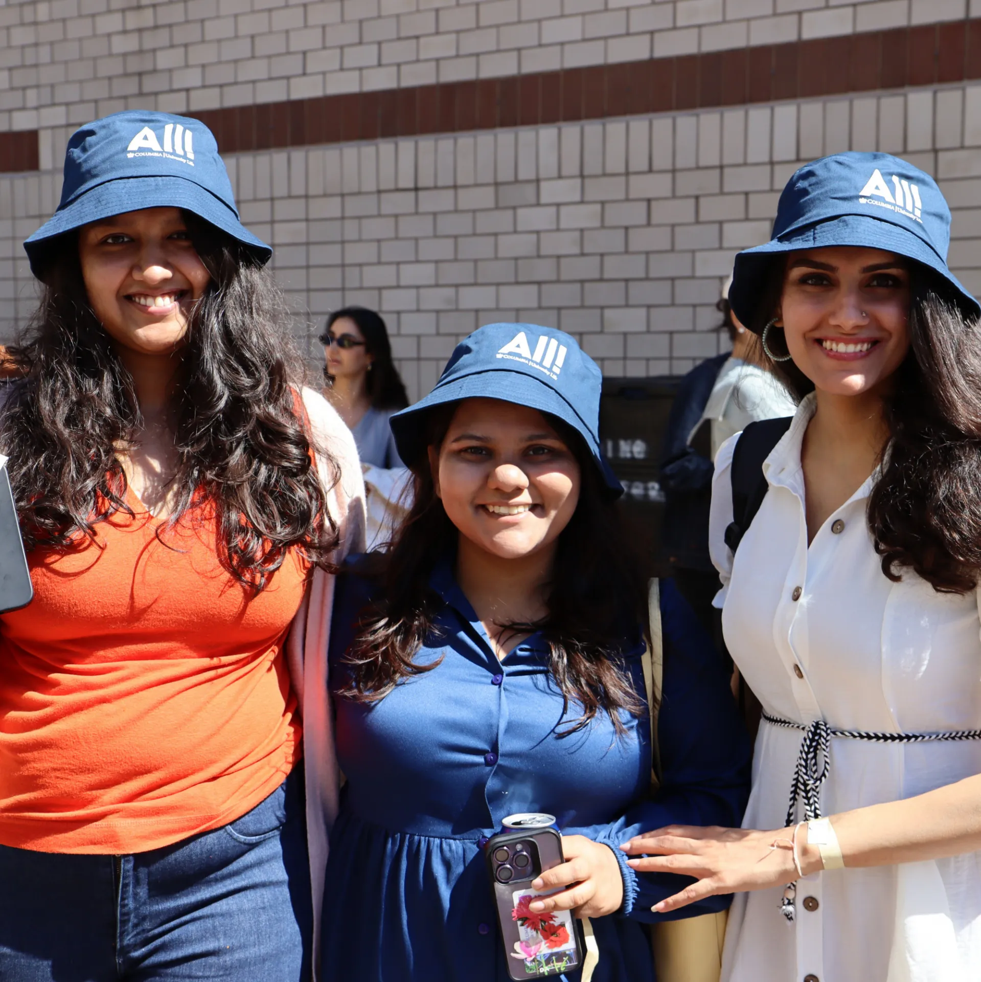 Students wearing ALL merch at a community connections event