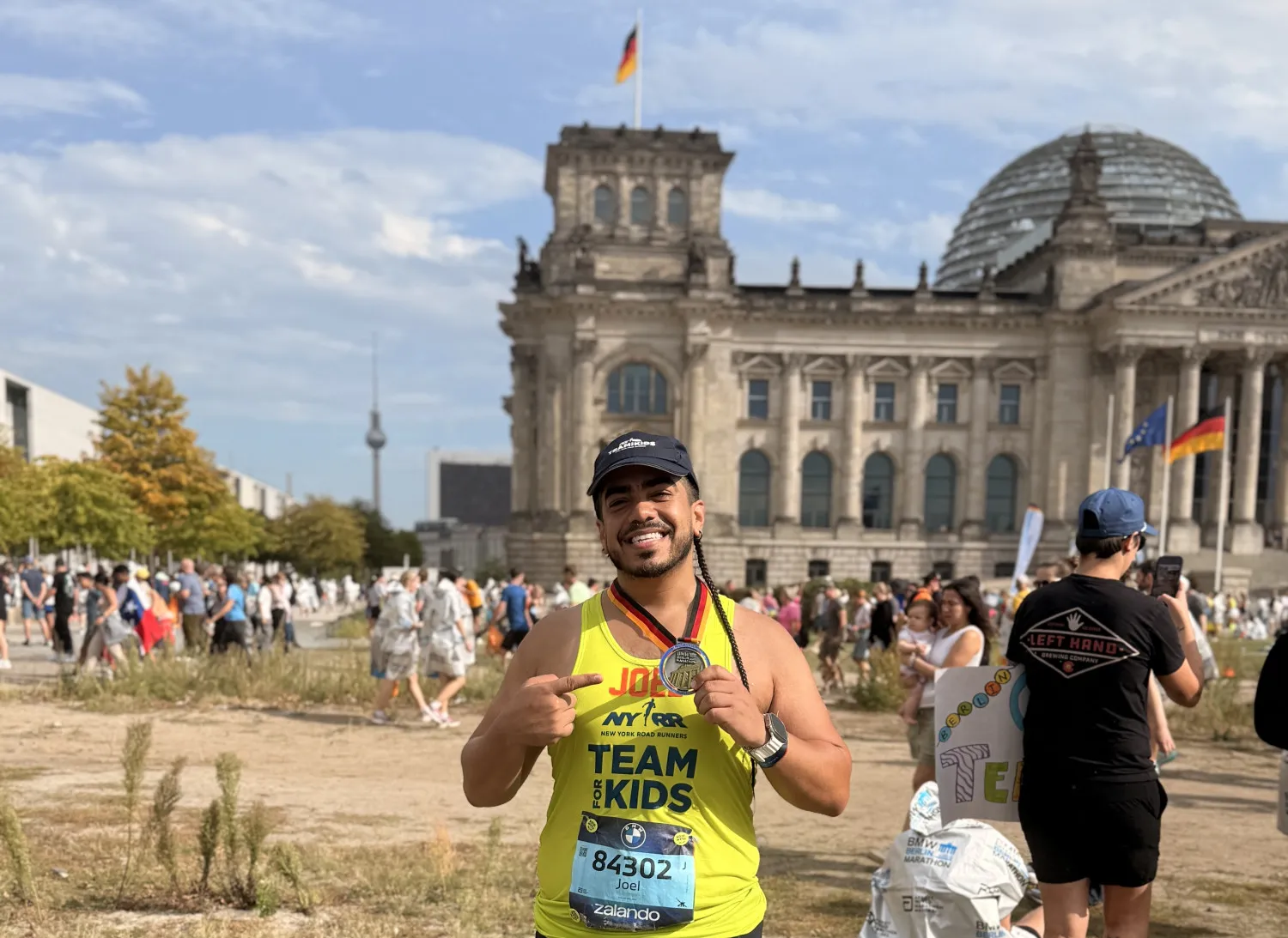Joel Teron (GS'27) standing in front of a Berlin monument after completing the Berlin Marathon.