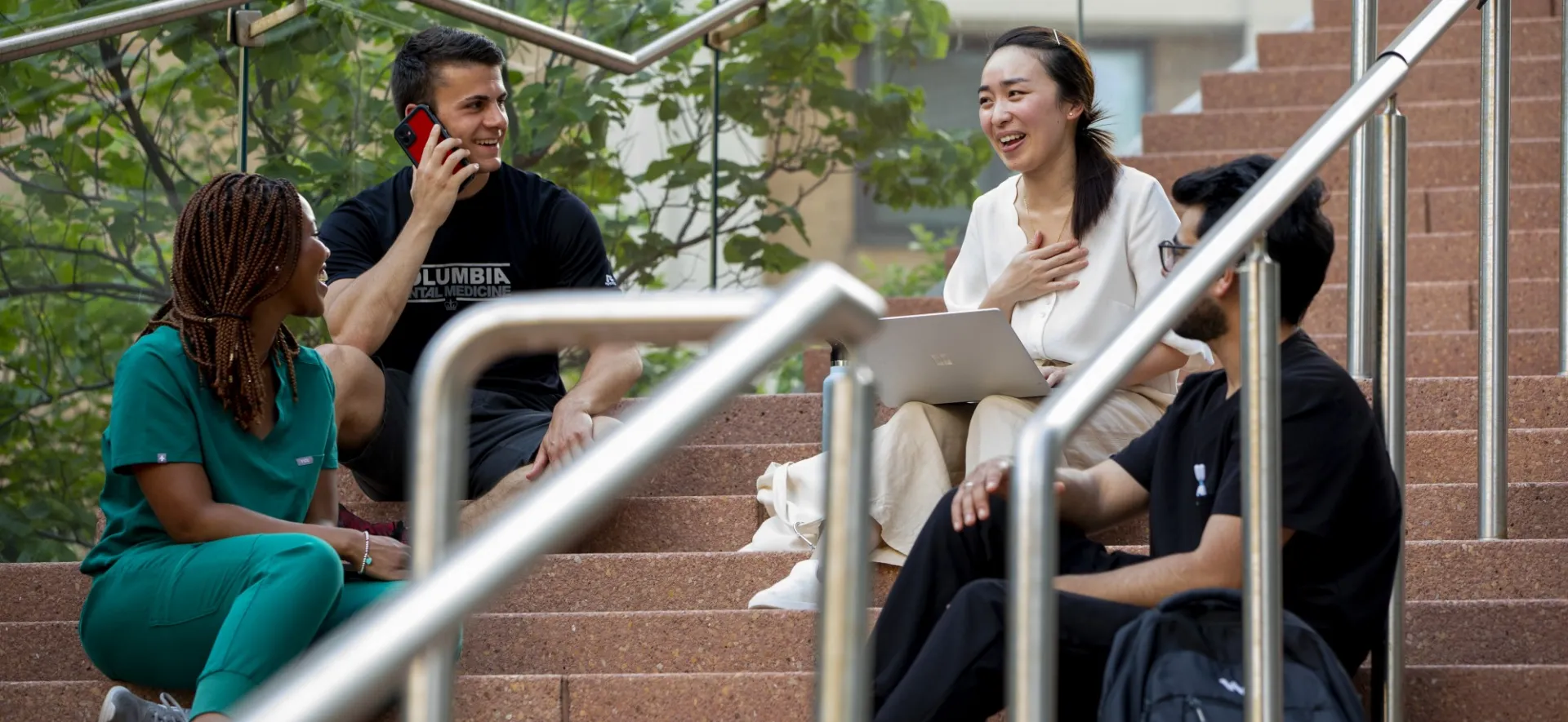 students sit on steps