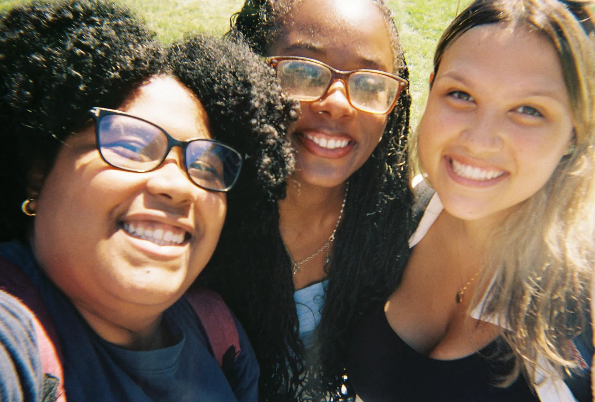 From left to right; Giovanna Corcino, Makeda Byfield, and Kelssie Sarkar smiling at the camera in a selfie 