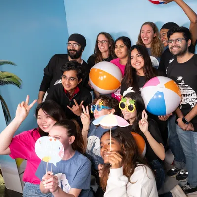 Events Council Members Pose with beach balls at Low Lounge Summer in December