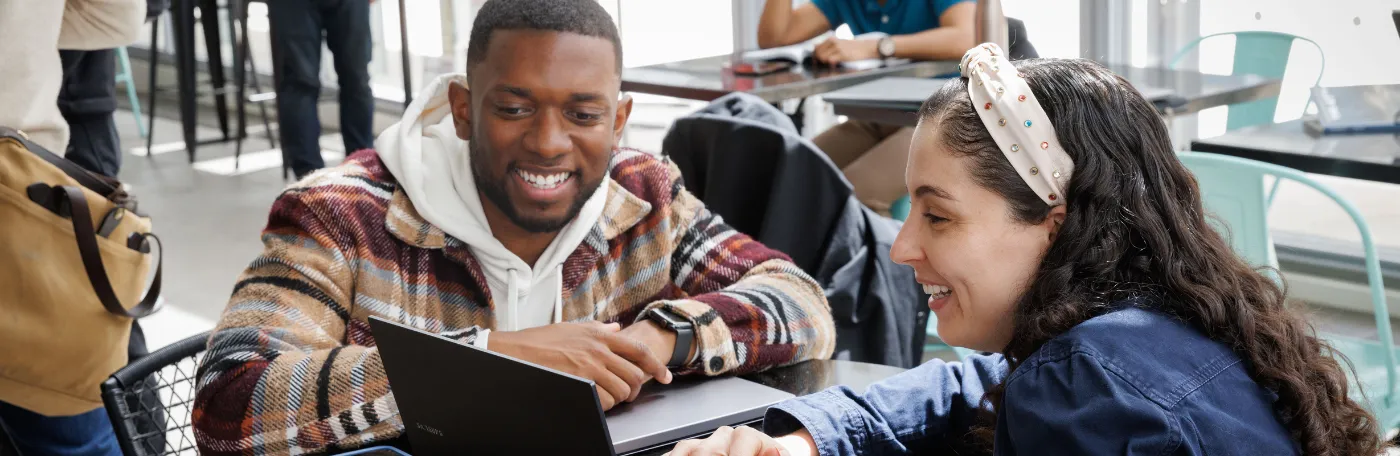 two student look at computer
