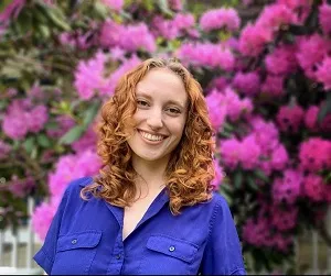 Madison smiles in front of flowers