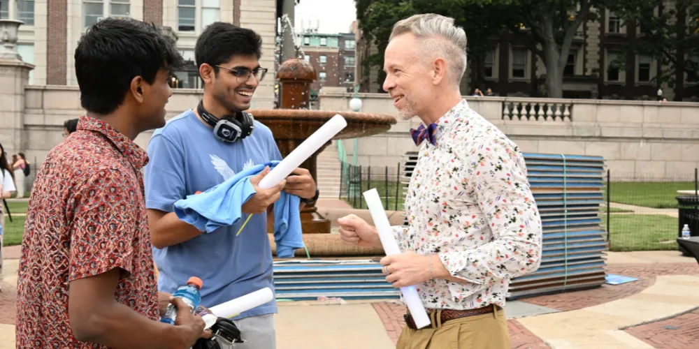 Three people chatting on Low Plaza