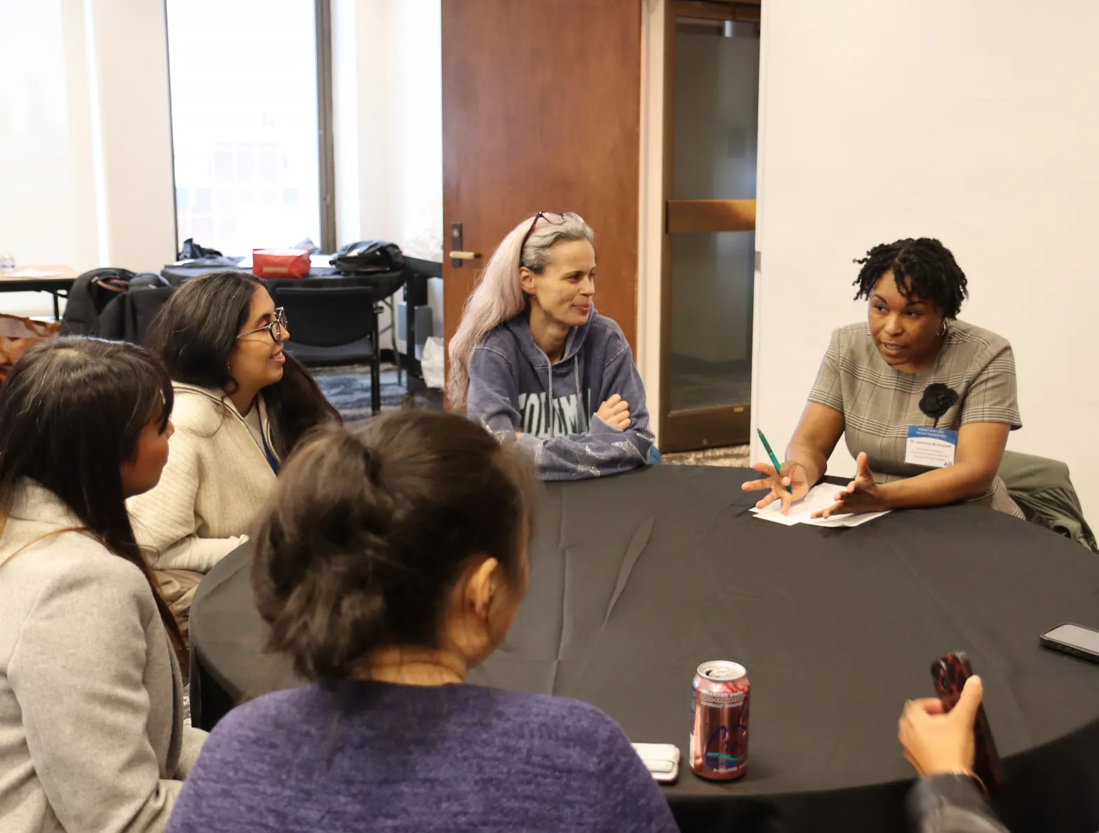 a group of students sitting around a table at a Faculty Round Table event