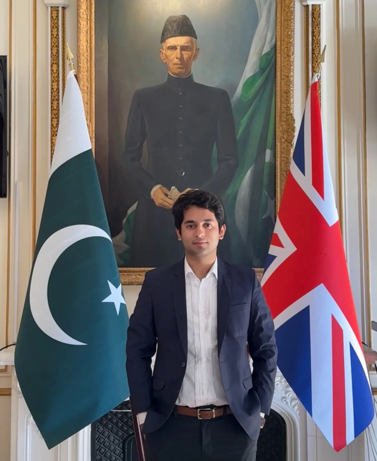 Haris Shah standing in front of a portrait