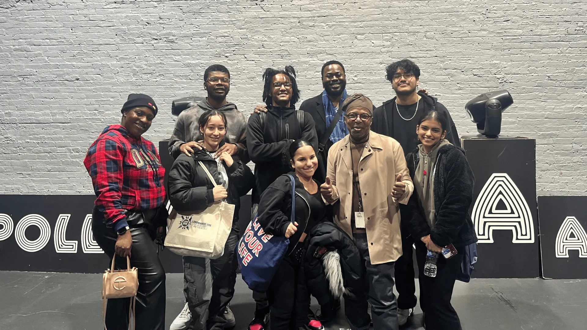 Group poses outside Apollo Theater